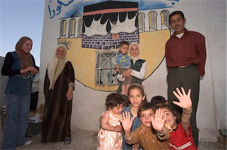 family portrait painting - Local family with wall painting of Mecca, Apamea (Qalat at al-Mudiq), Syria, Middle East Stock Photo - Rights-Managed, Code: 841-03056518