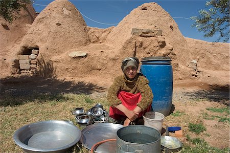 Local woman washing dishes in front of beehive houses built of brick and mud, Srouj village, Syria, Middle East Stock Photo - Rights-Managed, Code: 841-03056530