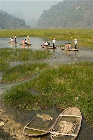 simsearch:841-02722965,k - Punting boats on delta river, limestone mountain scenery, Van Long, Ninh Binh, south of Hanoi, North Vietnam, Southeast Asia, Asia Stock Photo - Rights-Managed, Code: 841-03056731
