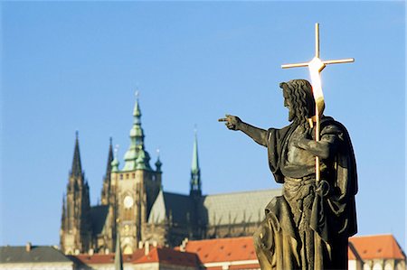 simsearch:841-03031390,k - Statue of St. John the Baptist, dating from 1857, on Charles Bridge, pointing to Gothic St. Vitus Cathedral at Prague Castle, Stare Mesto, Prague, Czech Republic, Europe Stock Photo - Rights-Managed, Code: 841-03056928