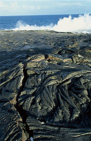 pahoehoe - Fresh pahoehoe or ropey lava, close to where steam rises from lava entering the sea on the southeast Puna coast, Big Island, Hawaii, Hawaiian Islands, United States of America, Pacific, North America Stock Photo - Rights-Managed, Code: 841-03067360