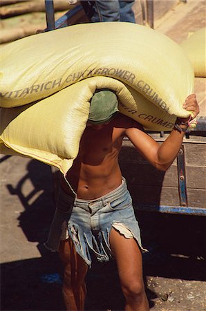 Stevedore carrying sacks at the docks in Iloilo City, Panay, Visayan Islands, Philippines, Southeast Asia, Asia Stock Photo - Rights-Managed, Code: 841-03067460