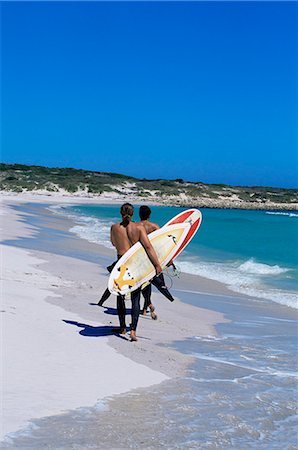 Two surfers walking with their boards on Kommetjie beach, Cape Town, South Africa, Africa Stock Photo - Rights-Managed, Code: 841-03062071