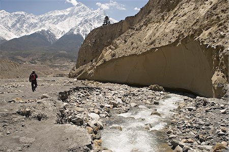 simsearch:841-02918757,k - Trekker on the Annapurna circuit trek, the high peak in the distance is one of the Nilgiris, part of The Grand Barrier, Jomsom, Himalayas, Nepal, Asia Stock Photo - Rights-Managed, Code: 841-03062419