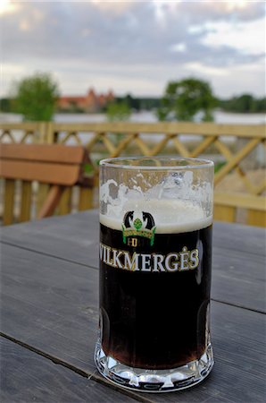 Vilkmerges, Lithuanian dark beer, with Trakai Castle in the background, Lithuania, Baltic States, Europe Stock Photo - Rights-Managed, Code: 841-03062962