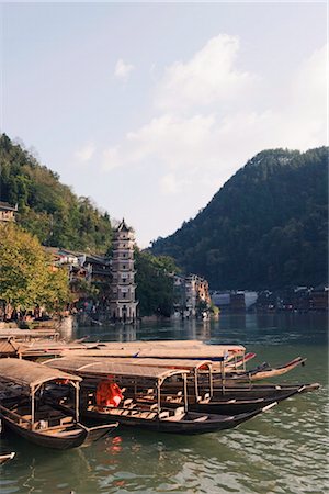 Boats tied up on a river in the old town of Fenghuang, Hunan Province, China, Asia Stock Photo - Rights-Managed, Code: 841-03505575