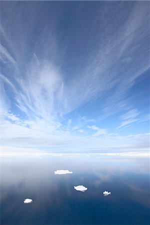 Calm water off the coast of Spitsbergen Island with four small chunks of sea ice, Svalbard Islands, Arctic, Norway, Scandinavia, Europe Stock Photo - Rights-Managed, Code: 841-03506117