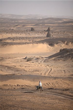 A man on mule-back traverses the desert around the ancient city of Old Dongola, Sudan, Africa Stock Photo - Rights-Managed, Code: 841-03507922