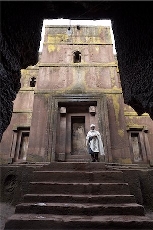 A priest stands at the entrance to the rock-hewn church of Bet Giyorgis (St. George), in Lalibela, UNESCO World Heritage Site, Ethiopia, Africa Stock Photo - Rights-Managed, Code: 841-03502455
