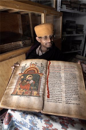 A priest goes through an ancient manuscript at the monastery of Kebran Gabriel, on an island on Lake Tana, Ethiopia, Africa Foto de stock - Con derechos protegidos, Código: 841-03502463