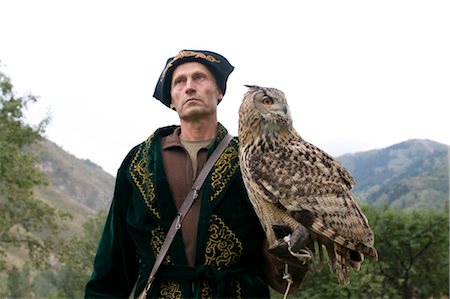 Kyrgyz eagle hunter with a rock eagle-owl (Bubo bengalensis), Sunkar Eagle Farm, Kazakhstan, Central Asia Stock Photo - Rights-Managed, Code: 841-03520102