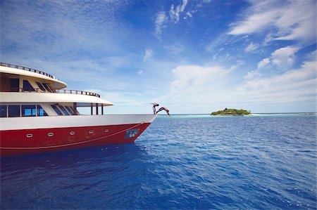 full length - Young people jumping from boat into sea, Maldives, Indian Ocean, Asia Stock Photo - Rights-Managed, Code: 841-03675007