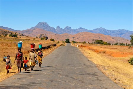 People walking along a street in the background Pic Bobby (Pic d'Imarivolanitra) in the Andringitra National Park, Madagascar, Africa Stock Photo - Rights-Managed, Code: 841-03676770