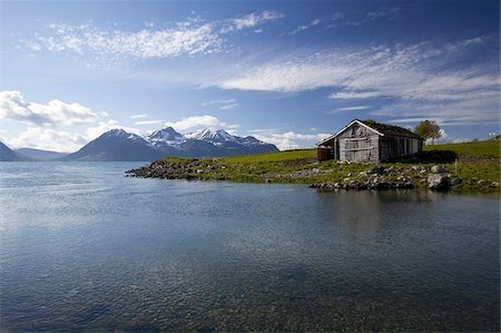 snow and grass - Cabin with traditional grass roof overlooking a fjord and snowy mountains in Lyngen Peninsula, Troms county, Norway, Scandinavia, Europe Stock Photo - Rights-Managed, Code: 841-03676871