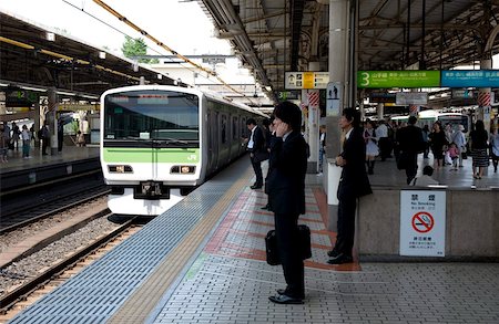 simsearch:841-06503239,k - Businessman waiting for the Yamanote loop line train just arriving at the JR Ueno railway station in Tokyo, Japan, Asia Stock Photo - Rights-Managed, Code: 841-03676981