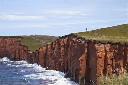 pictures of people in quebec - Person walking on red sandstone cliff on Cap-aux-Meules Island in the Iles de la Madeleine (Magdalen Islands), Quebec, Canada, North America Stock Photo - Rights-Managed, Code: 841-03677082