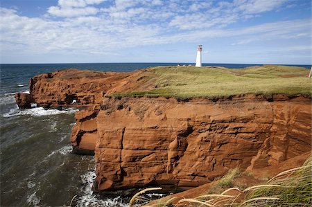 Red sandstone cliff and lighthouse on Cap-aux-Meules Island on the Iles de la Madeleine (Magdalen Islands), Quebec, Canada, North America Foto de stock - Con derechos protegidos, Código: 841-03677083