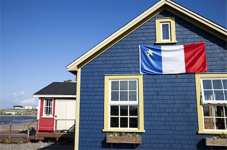 Acadian flag on blue house in La Grave, Ile Havre-Aubert, one of the Iles de la Madeleine (Magdalen Islands), Gulf of St. Lawrence, Quebec, Canada, North America Stock Photo - Rights-Managed, Code: 841-03677090