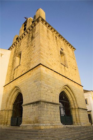 simsearch:841-05795381,k - The fortress like stone tower of medieval Faro Cathedral (Largo da Se) in Faro, Algarve, Portugal, Europe Stock Photo - Rights-Managed, Code: 841-03677211