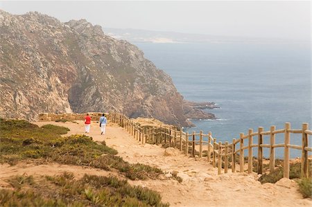 People walk along cliffs overlooking the Atlantic Ocean at Europe's most westerly point at Cabo da Roca, Portugal, Europe Stock Photo - Rights-Managed, Code: 841-03677226