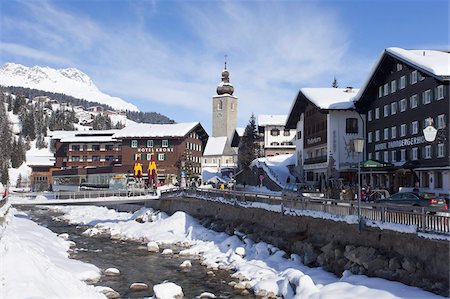 Hotel Krone, river and village church, Lech near St. Anton am Arlberg in winter snow, Austrian Alps, Austria, Europe Stock Photo - Rights-Managed, Code: 841-03677476