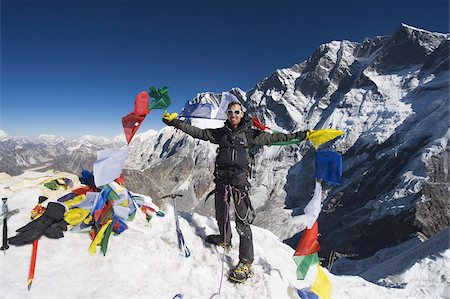 Climber holding prayer flags at the top of Island Peak, 6189m, Solu Khumbu Everest Region, Sagarmatha National Park, Himalayas, Nepal, Asia Fotografie stock - Rights-Managed, Codice: 841-03672833