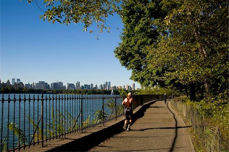 A jogger on the track around the reservoir in Central Park and the city skyline in the background, New York City, New York State, United States of America, North America Stock Photo - Rights-Managed, Code: 841-03867900