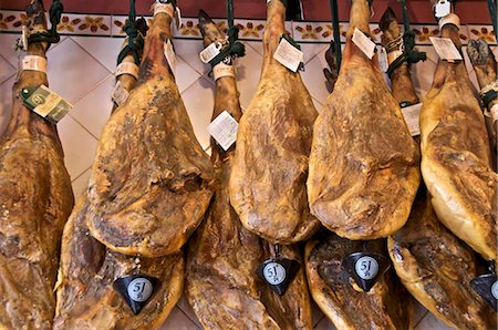 Spanish hams hanging in a restaurant bodega, Seville, Andalusia, Spain, Europe Fotografie stock - Rights-Managed, Codice: 841-03868093