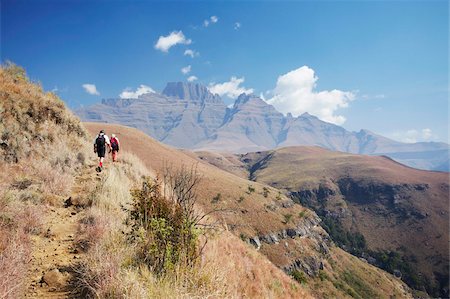 People hiking in Monk's Cowl Nature Reserve with Champagne Castle in background, Ukhahlamba-Drakensberg Park, UNESCO World Heritage Site, KwaZulu-Natal, South Africa, Africa Stock Photo - Rights-Managed, Code: 841-03870097