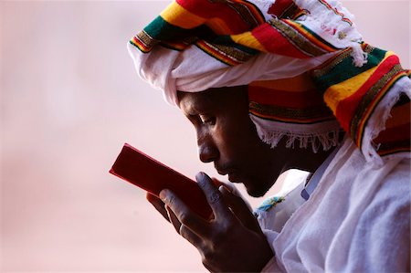 Faithful kissing a Bible outside a church in Lalibela, Ethiopia, Africa Stock Photo - Rights-Managed, Code: 841-03870569