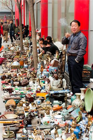 flea market in beijing china - Salesman smoking, crafts stalls, Panjiayuan flea market, Chaoyang District, Beijing, China, Asia Stock Photo - Rights-Managed, Code: 841-03871447