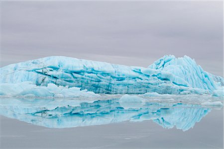 small town america - Blue iceberg from Sheridan Glacier reflects on thin film of water over ice, Chugach Mountains near Cordova, Southcentral Alaska, Winter Stock Photo - Rights-Managed, Code: 854-05974477