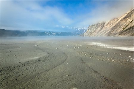 parco nazionale della baia del ghiacciaio - Rocks strewn on mud flat at Muir Inlet, Glacier Bay National Park & Preserve, Southeast Alaska, Summer Fotografie stock - Rights-Managed, Codice: 854-05974531
