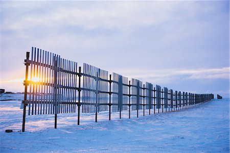 fence in snow - Sun setting behind a snow fence, Barrow, Winter, Arctic Alaska, USA. Stock Photo - Rights-Managed, Code: 854-08028120