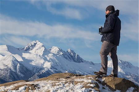 southcentral alaska - Male Hiker Taking In The View Of The Snowcapped Chugach Mountains From The Bodenburg Butte, Matanuska Valley, Southcentral Alaska, Spring Stock Photo - Rights-Managed, Code: 854-08028206