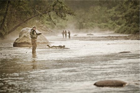 Fly fisherman casting for Silver Salmon in the Anchor River at Anchor Point on the Kenai Peninsula in Southcentral Alaska during Fall Foto de stock - Con derechos protegidos, Código: 854-02954977