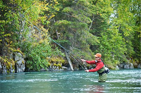 pesca con la mosca - Woman fly fishing on the upper Kenai River on the Kenai Peninsula of Southcentral Alaska during Fall Fotografie stock - Rights-Managed, Codice: 854-02954986