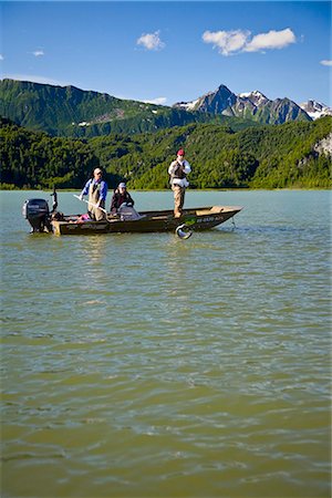 simsearch:854-02955134,k - Spin fisherman reels in a Silver Salmon while standing in a boat in Big River Lakes in the  Redoubt Bay State Critical Habitat Area in Southcentral Alaska during Summer Stock Photo - Rights-Managed, Code: 854-02955007