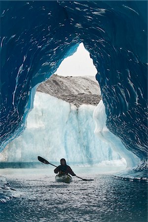 photos ice floats - Sea Kayaker paddles through an ice cave amongst giant icebergs near Bear Glacier in Resurrection Bay near Seward, Alaska Stock Photo - Rights-Managed, Code: 854-02955124