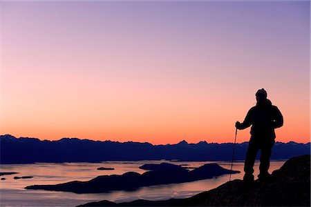 simsearch:854-02955228,k - Male Hiker standing on ridge overlooking Lynn Canal & Berner's Bay near Juneau Alaska at sunset Stock Photo - Rights-Managed, Code: 854-02955239