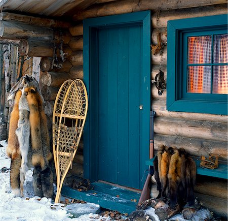 door equipment - Trappers cabin w/traps fur pelts snowshoes rifle outside doorway Alaska Winter Stock Photo - Rights-Managed, Code: 854-02955482