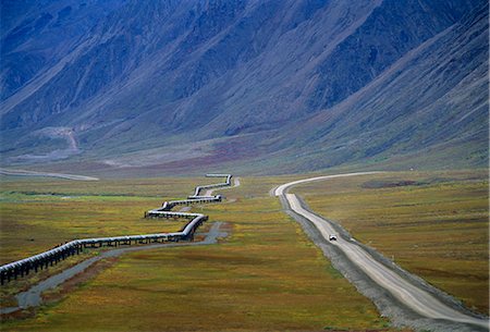 pipeline industry - Vehicle travels on the Dalton Highway next to the Trans-Alaska pipeline in the Arctic of Alaska during Summer. Stock Photo - Rights-Managed, Code: 854-02955532