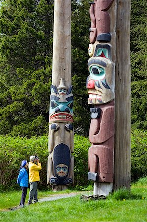 ethnic, photographer - Tourist photographing totem pole at Saxman Totem Park near Ketchikan Alaska Southeast Summer Stock Photo - Rights-Managed, Code: 854-02955612