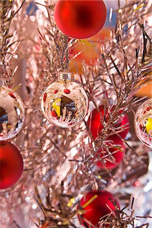 Silver and red Christmas tree bulb ornaments hanging from bright tinsel tree reflecting other ornaments winter Alaska Stock Photo - Rights-Managed, Code: 854-02955833