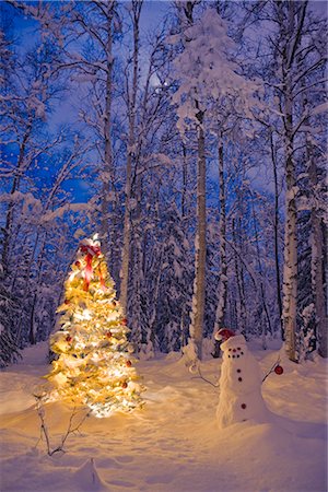 Snowman with santa hat hanging ornaments on a  Christmas tree in a snow covered birch forest in Southcentral Alaska Stock Photo - Rights-Managed, Code: 854-02955906