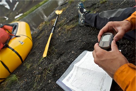 satelite - Close up of a woman's hands as she checks her position on a GPS before heading down the Aniakchak River in Aniakchak National Monument and Preserve in Southwest Alaska Stock Photo - Rights-Managed, Code: 854-02955916