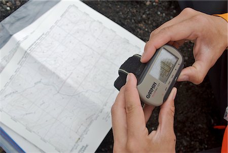 Close up of a woman's hands as she checks her position on a GPS before heading down the Aniakchak River in Aniakchak National Monument and Preserve in Southwest Alaska Stock Photo - Rights-Managed, Code: 854-02955917