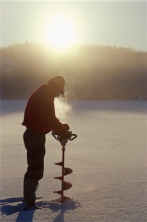 pesca en el hielo - Icefisherman drilling frozen Hidden Lake Southcentral Alaska winter scenic Foto de stock - Con derechos protegidos, Código: 854-03361753