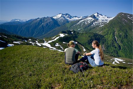 Hikers rest and admire the view in the alpine above Amalga Basin in the Tongass Forest, near Juneau, Alaska. Stock Photo - Rights-Managed, Code: 854-03361844