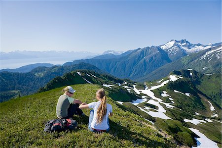 Hikers rest and admire the view in the alpine above Amalga Basin in the Tongass Forest, near Juneau, Alaska. Stock Photo - Rights-Managed, Code: 854-03361845